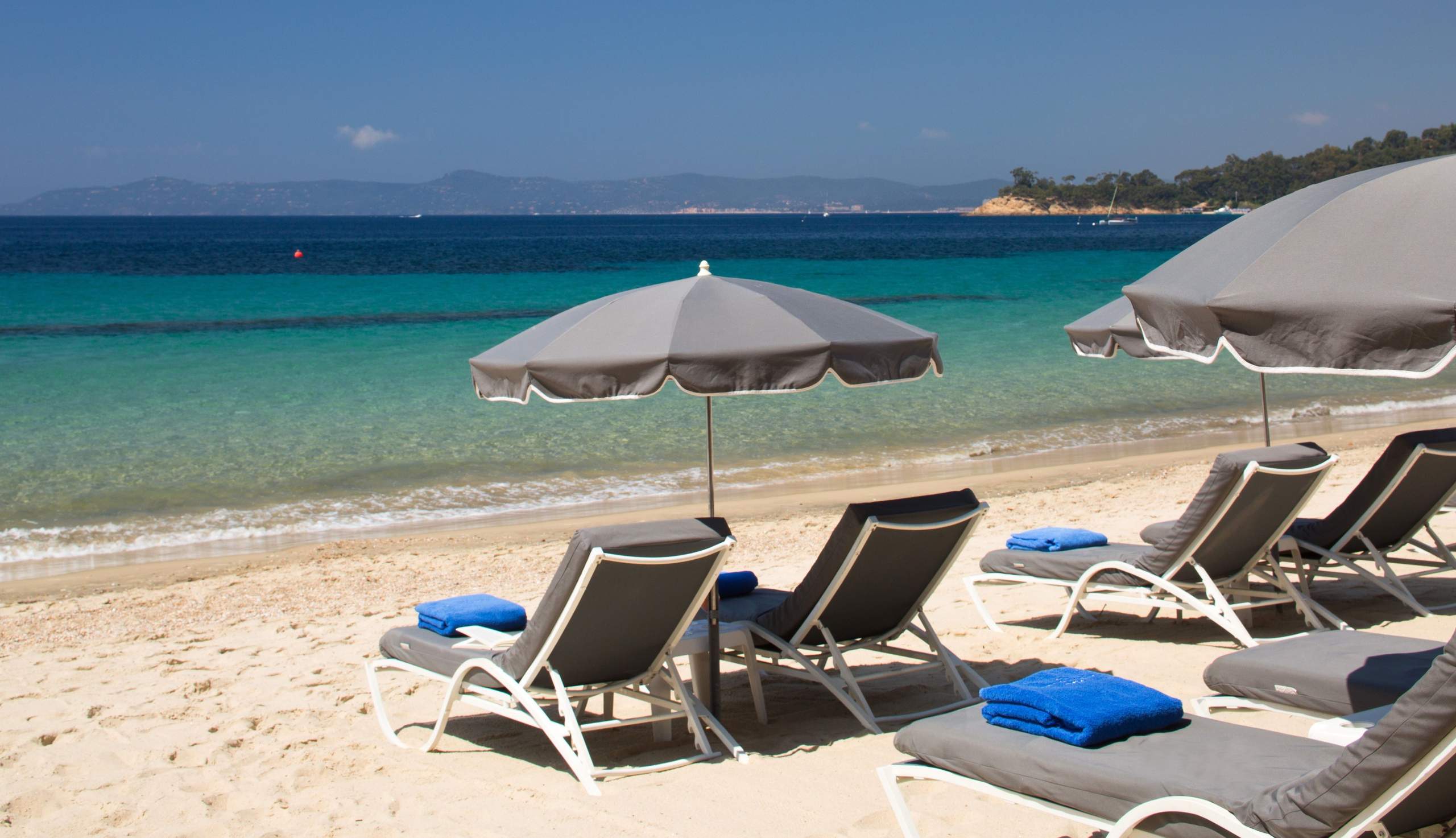 Deck chairs and umbrellas by the sea